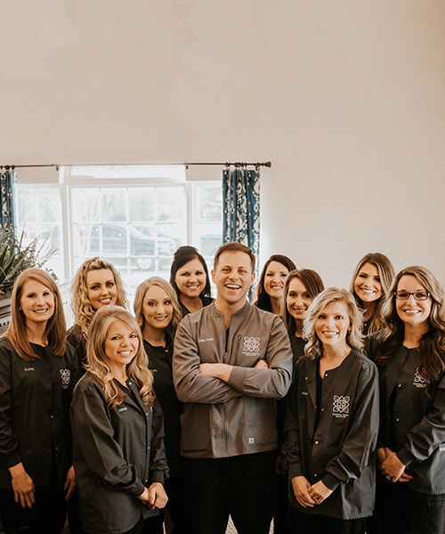 The entire team of Magnolia Family Dentistry inside the dental office 